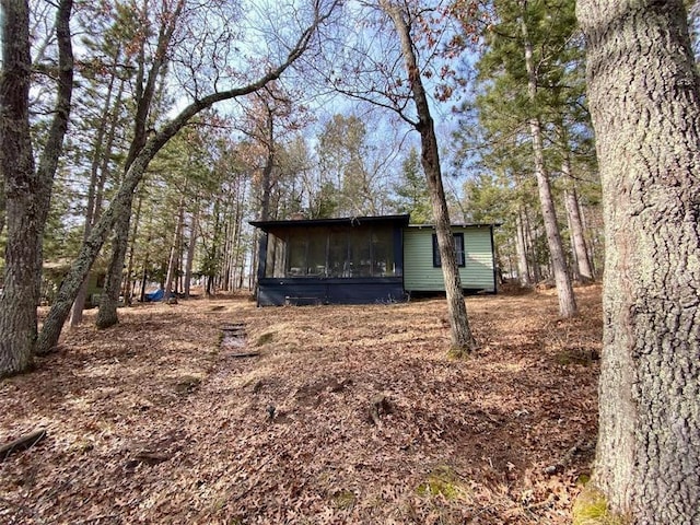 view of outdoor structure featuring a sunroom