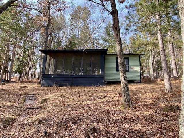 view of outbuilding featuring a sunroom