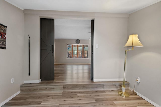 empty room featuring baseboards and wood finished floors