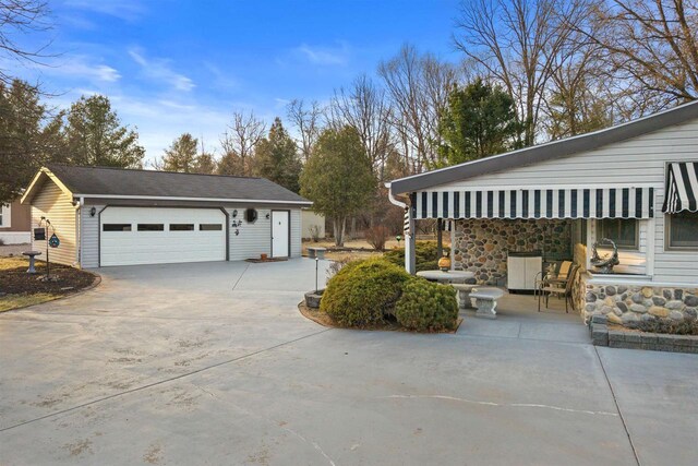 view of home's exterior with stone siding and a garage