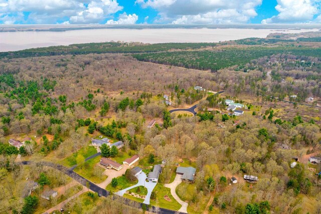 aerial view featuring a water view and a wooded view