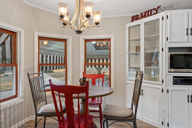 dining room featuring dark wood-type flooring, a chandelier, and ornamental molding