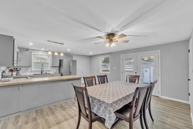 dining room with recessed lighting, french doors, light wood finished floors, baseboards, and ceiling fan