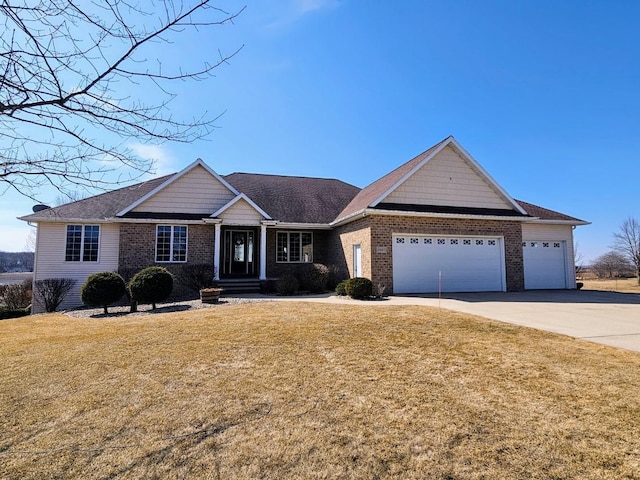 view of front of property featuring brick siding, a front lawn, concrete driveway, and an attached garage