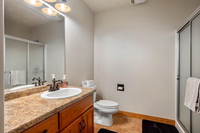 full bathroom with vanity, toilet, a stall shower, and tile patterned flooring