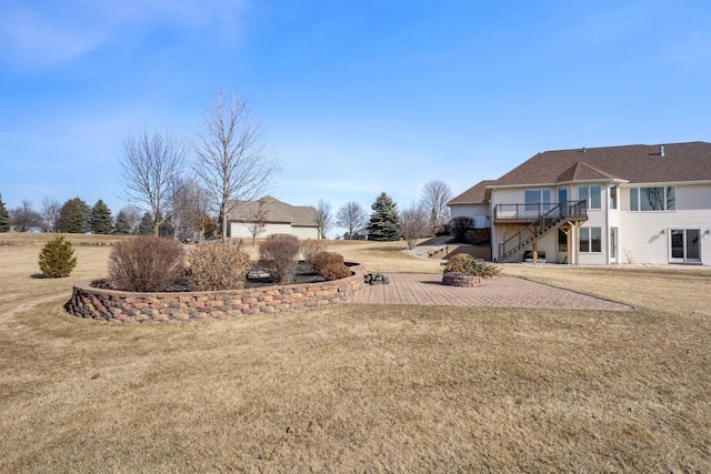 view of yard with a deck, a patio, and stairway