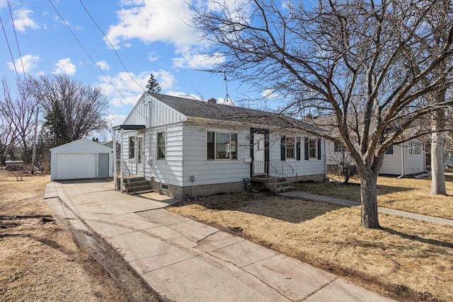 view of front facade with a garage, board and batten siding, an outdoor structure, and concrete driveway