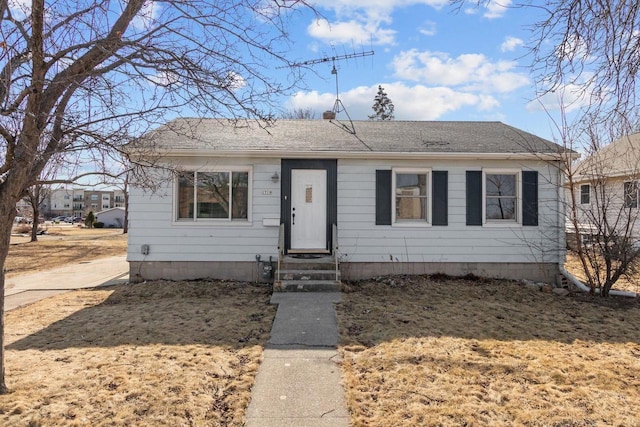 bungalow-style home featuring entry steps and roof with shingles