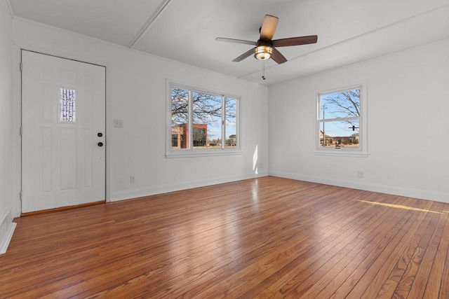 interior space featuring baseboards, a ceiling fan, and hardwood / wood-style flooring