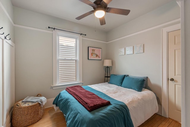 bedroom featuring a ceiling fan and hardwood / wood-style floors