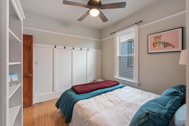 bedroom with light wood-style flooring and ceiling fan