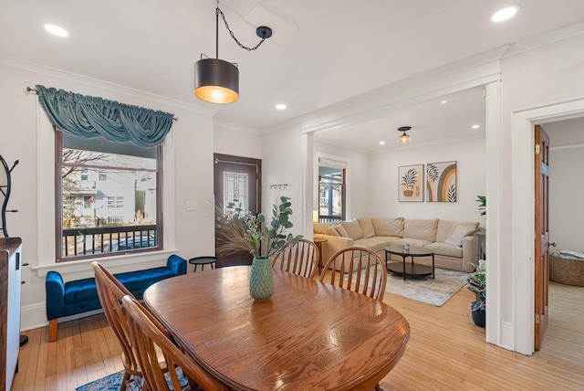 dining space featuring recessed lighting, light wood-type flooring, and crown molding