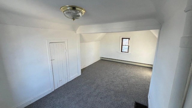 additional living space featuring vaulted ceiling, baseboard heating, visible vents, and carpet floors