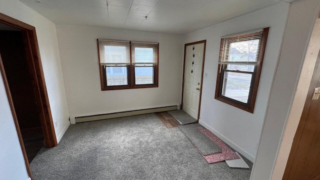 doorway to outside featuring a baseboard radiator, baseboards, and carpet flooring