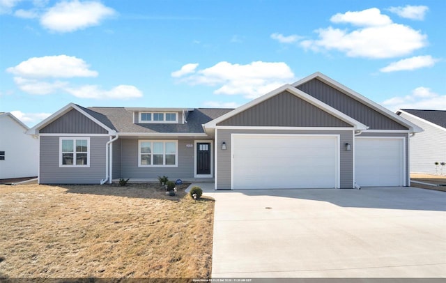 view of front facade with an attached garage, a shingled roof, and driveway