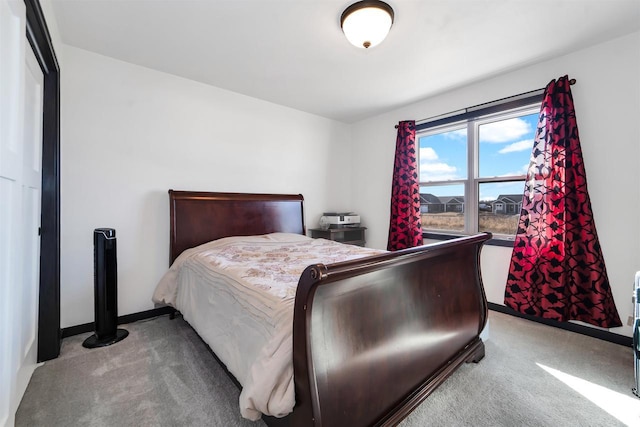 bedroom featuring baseboards and carpet flooring