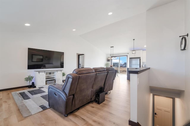 living area with lofted ceiling, light wood-style flooring, recessed lighting, and baseboards