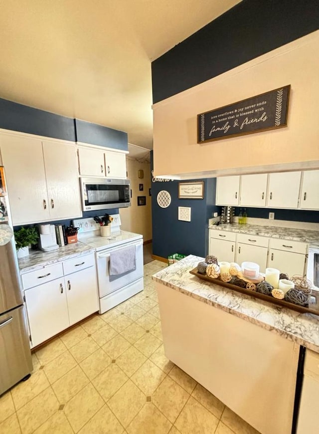 kitchen with appliances with stainless steel finishes and white cabinetry