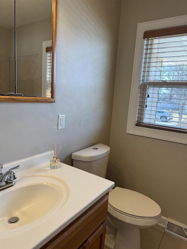 bathroom with vanity, toilet, visible vents, and tile patterned flooring