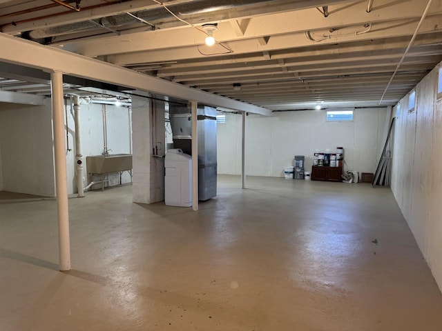 basement with washer / clothes dryer and a sink