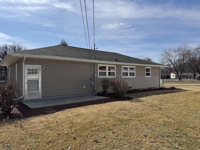 rear view of property with a lawn and a patio area