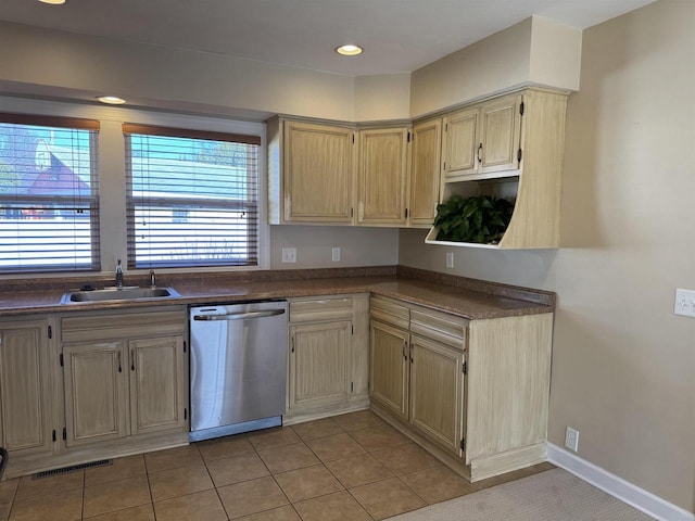 kitchen featuring light tile patterned floors, visible vents, a sink, dishwasher, and dark countertops