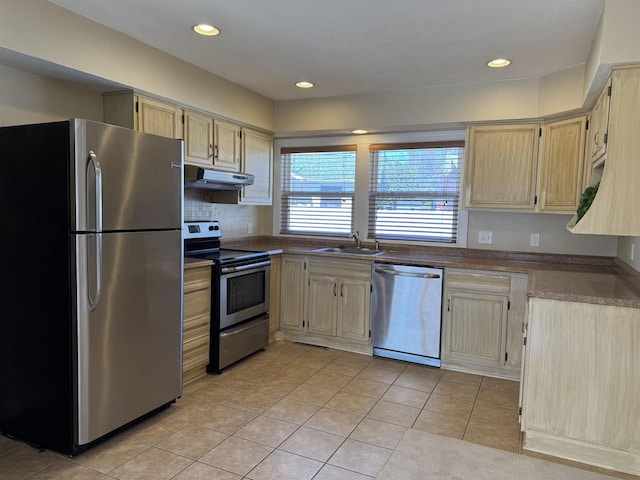 kitchen with a sink, under cabinet range hood, recessed lighting, stainless steel appliances, and light tile patterned flooring