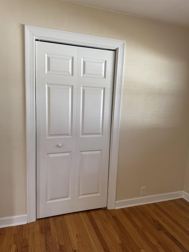 interior details featuring baseboards and wood finished floors