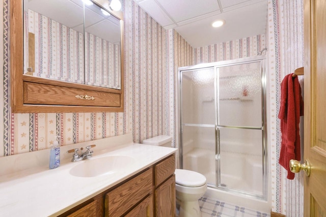 bathroom featuring wallpapered walls, a shower stall, and toilet