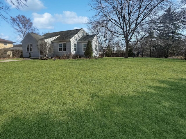 view of side of home featuring a lawn