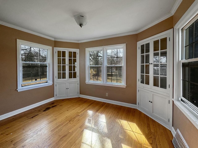 unfurnished dining area with baseboards, visible vents, and light wood finished floors