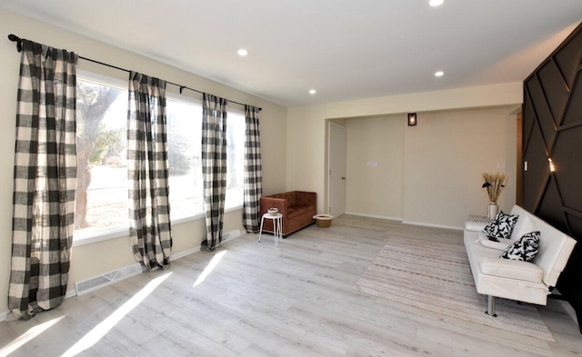 unfurnished room featuring recessed lighting, visible vents, a healthy amount of sunlight, and light wood-type flooring