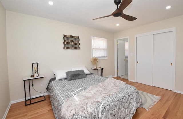 bedroom featuring a closet, recessed lighting, baseboards, and wood finished floors