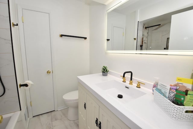 bathroom with toilet, marble finish floor, and vanity