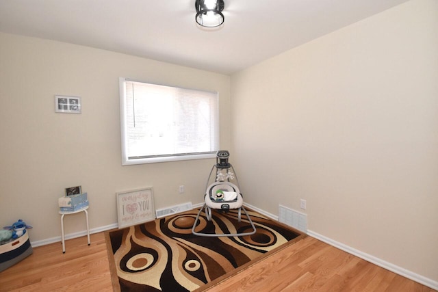 interior space with visible vents, baseboards, and light wood-style floors