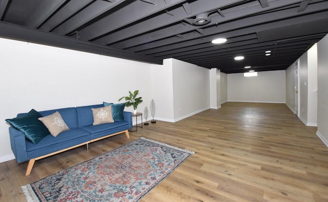 sitting room with baseboards and wood finished floors