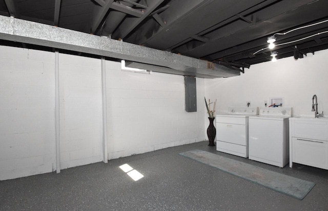 finished basement featuring electric panel, independent washer and dryer, concrete block wall, and a sink