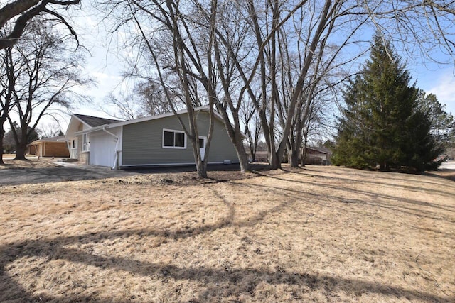 view of side of home featuring driveway