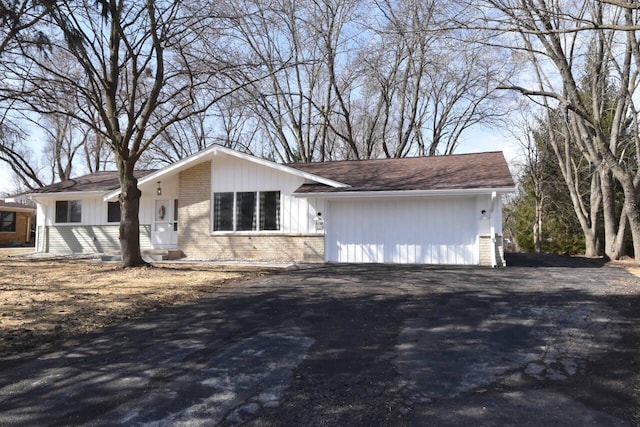 view of front of house featuring brick siding and driveway