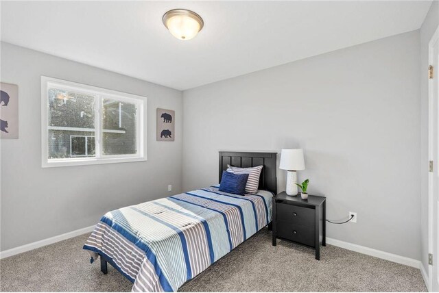 carpeted bedroom featuring baseboards