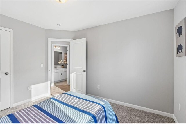 bedroom with baseboards and light carpet