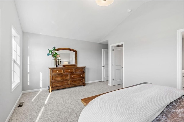 bedroom with lofted ceiling, carpet flooring, baseboards, and visible vents