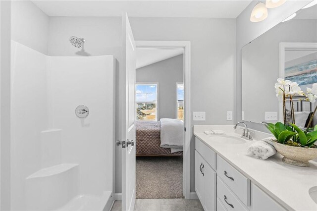 bathroom with a sink, a shower, ensuite bath, and double vanity