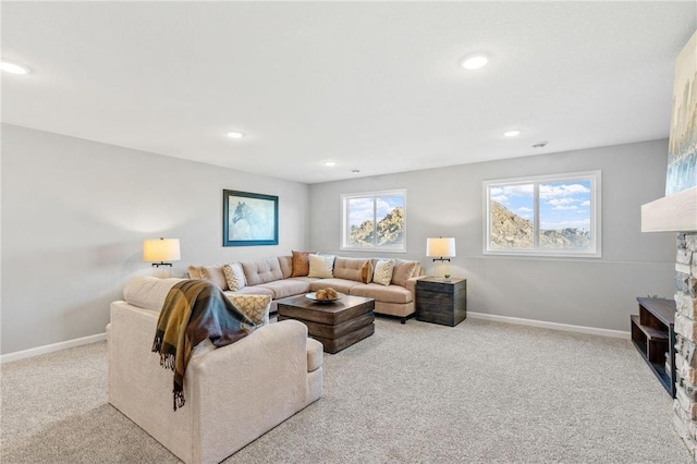 carpeted living area featuring recessed lighting and baseboards