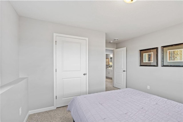 bedroom with light carpet and baseboards