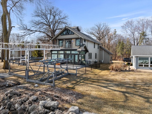 rear view of property with a balcony