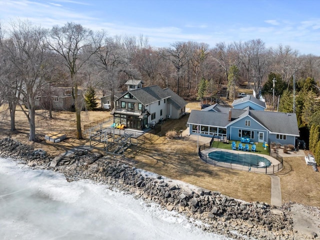 back of house featuring a patio, fence, and a fenced in pool