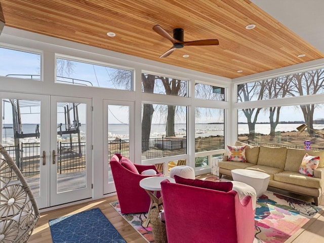 sunroom featuring plenty of natural light, french doors, wood ceiling, and ceiling fan