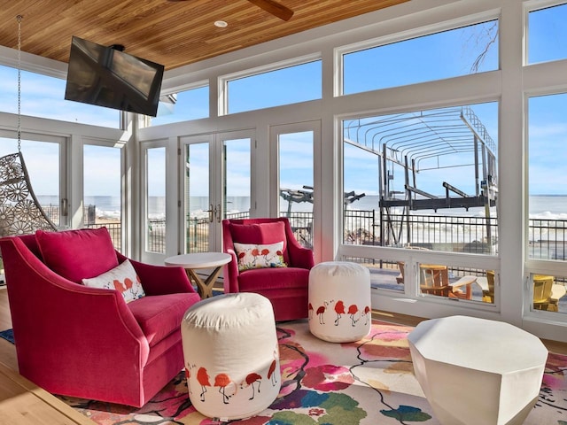 sunroom / solarium with a water view and wood ceiling