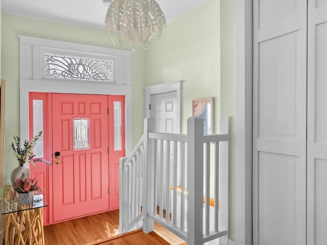 foyer entrance featuring an inviting chandelier and wood finished floors